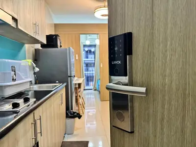 a kitchen with a door to a kitchenasteryasteryasteryasteryasteryasteryasteryastery at Room 643 Pool View Shore 2 Residences near PICC & SM MOA by Prime Stay in Manila