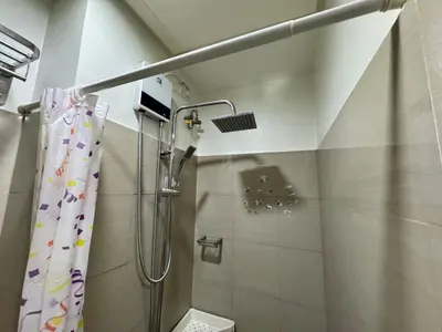 a bathroom with a shower with a shower curtain at Room 643 Pool View Shore 2 Residences near PICC & SM MOA by Prime Stay in Manila