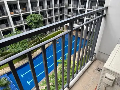 a balcony of a building with a blue swimming pool at 640 Coffee Room Shore 2 Residences MOA Pool View by Prime Stay in Manila