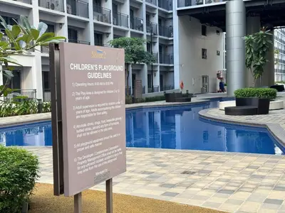 a sign in front of a building with a swimming pool at 640 Coffee Room Shore 2 Residences MOA Pool View by Prime Stay in Manila
