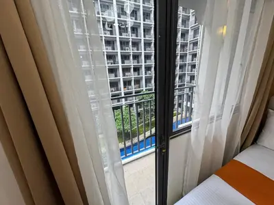 a window with a view of a building at 640 Coffee Room Shore 2 Residences MOA Pool View by Prime Stay in Manila