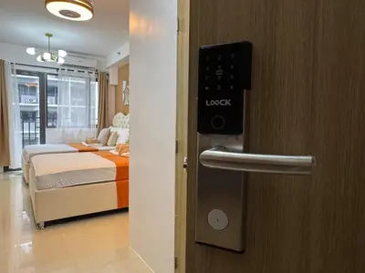 a hotel room with a door with a key card at 640 Coffee Room Shore 2 Residences MOA Pool View by Prime Stay in Manila