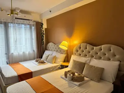 a hotel room with two beds and a window at 1645 Coffee Room Shore 2 Residences Pool View by Prime Stay MOA in Manila
