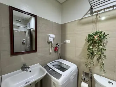 a bathroom with a sink and a toilet and a mirror at 1645 Coffee Room Shore 2 Residences Pool View by Prime Stay MOA in Manila