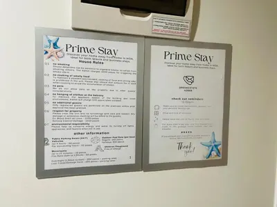 two white signs hanging on a wall at 1645 Coffee Room Shore 2 Residences Pool View by Prime Stay MOA in Manila