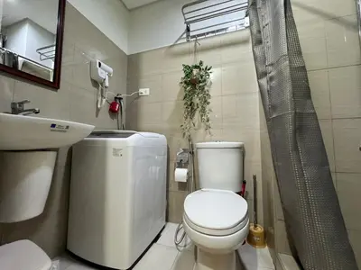 a bathroom with a toilet and a sink and a shower at 1645 Coffee Room Shore 2 Residences Pool View by Prime Stay MOA in Manila