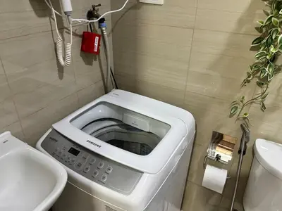 a washing machine in a bathroom with a sink at 1645 Coffee Room Shore 2 Residences Pool View by Prime Stay MOA in Manila