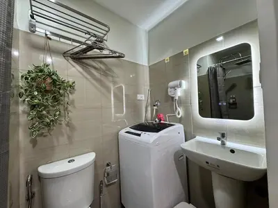 a bathroom with a white toilet and a sink at Coffee Room 1666 Shore 2 Residences Tower 1 Pool View by Prime Stay MOA in Manila