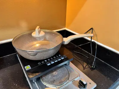 a pan sitting on top of a stove at Coffee Room 1666 Shore 2 Residences Tower 1 Pool View by Prime Stay MOA in Manila