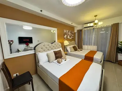 a hotel room with two beds and a television at Coffee Room 1666 Shore 2 Residences Tower 1 Pool View by Prime Stay MOA in Manila