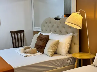 a bed with a headboard with pillows and a lamp at Coffee Room 1666 Shore 2 Residences Tower 1 Pool View by Prime Stay MOA in Manila