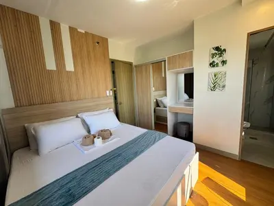 a bedroom with a bed with two teddy bears on it at 2BR facing Manila Bay & City View Shore 2 Residences MOA with Parking by Prime Stay in Manila