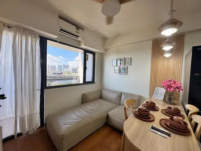 a living room with a couch and a table at 2BR facing Manila Bay & City View Shore 2 Residences MOA with Parking by Prime Stay in Manila