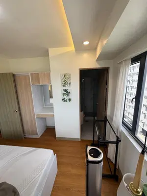 a bedroom with a bed and a room with a kitchen at 2BR facing Manila Bay & City View Shore 2 Residences MOA with Parking by Prime Stay in Manila