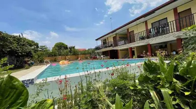 a swimming pool next to a building with people in it at Casa Ylaya - a New Private Pool Getaway in General Trias