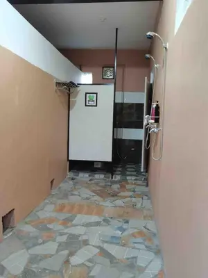 a bathroom with a shower and a tile floor at Casa Ylaya - a New Private Pool Getaway in General Trias