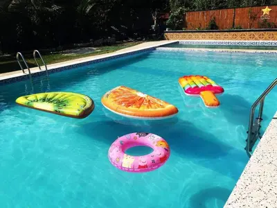 a swimming pool with inflatables in the water at Casa Ylaya - a New Private Pool Getaway in General Trias