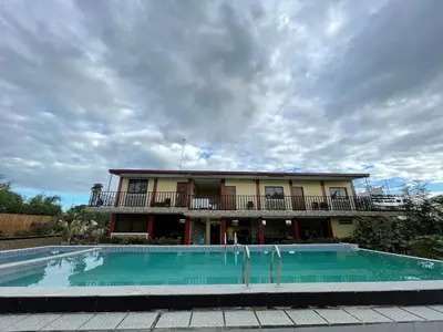 a house with a swimming pool in front of a building at Casa Ylaya - a New Private Pool Getaway in General Trias