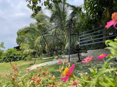 a garden with pink flowers in front of a fence at Casa Ylaya - a New Private Pool Getaway in General Trias