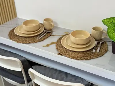 a table with three hats and plates on it at Shore 2 Residences RM 19106 Pool View by Prime Stay MOA in Manila
