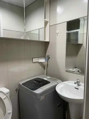 a small bathroom with a toilet and a sink at Suite A Deluxe Near SM MALL OF ASIA in Manila