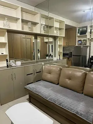 a living room with a couch in a kitchen at Suite A Deluxe Near SM MALL OF ASIA in Manila