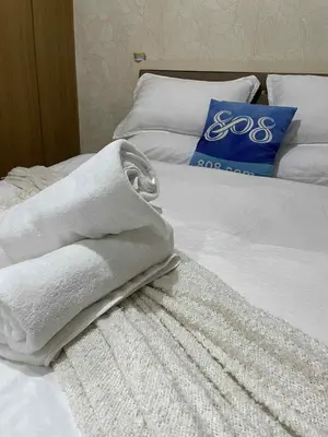 a bed with white towels on top of it at Suite A Deluxe Near SM MALL OF ASIA in Manila
