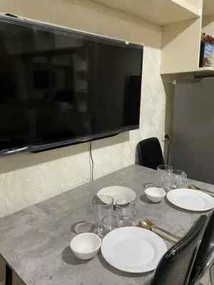 a table with white plates and glasses on it at Suite A Deluxe Near SM MALL OF ASIA in Manila