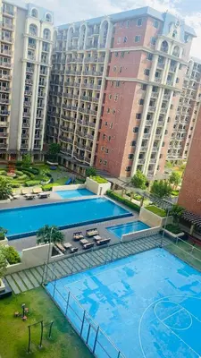 an overhead view of two pools in a large apartment building at H Cloud Suites Monarch Parksuites near MOA and Casino City in Manila