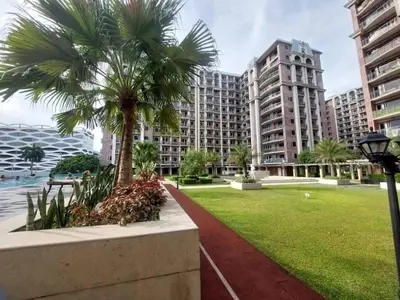 a palm tree in a park in front of a building at H Cloud Suites Monarch Parksuites near MOA and Casino City in Manila