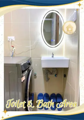 a bathroom with a sink and a washing machine at Condo with Pool and Balcony near Megamall Ortigas Center in Manila