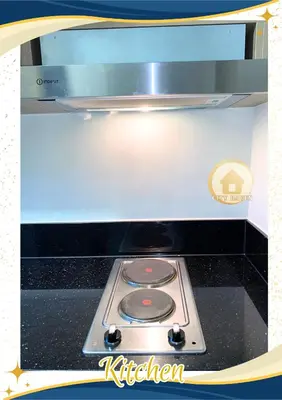 a stove top oven with a kitchen sign on it at Condo with Pool and Balcony near Megamall Ortigas Center in Manila