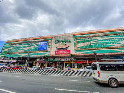 a white van parked in front of a building at Cozy Oasis Free pool, netflix, playground in Manila