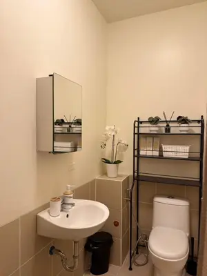 a bathroom with a toilet and a sink at The Camden Place 1BR Condo Apartment in Manila