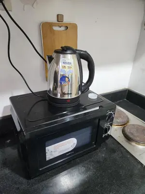 a tea kettle is sitting on top of a microwave at SeaResidence TowerA,Netflex,Wifi near MOA in Manila