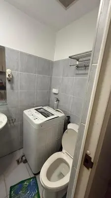 a small bathroom with a toilet and a sink at SeaResidence TowerA,Netflex,Wifi near MOA in Manila