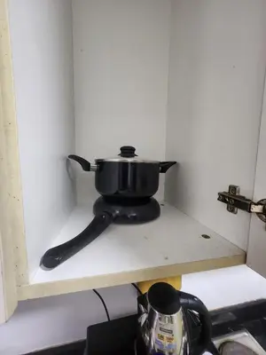 a pot sitting on a shelf in a kitchen at SeaResidence TowerA,Netflex,Wifi near MOA in Manila