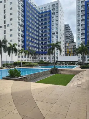 a swimming pool in a city with tall buildings at SeaResidence TowerA,Netflex,Wifi near MOA in Manila