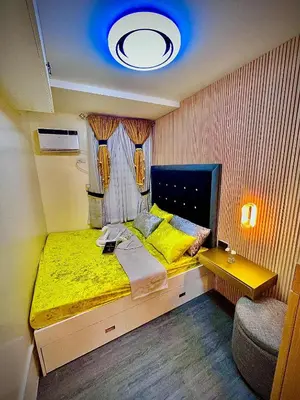 a bedroom with a large bed with a yellow blanket at Palacio Inglaterra in Manila