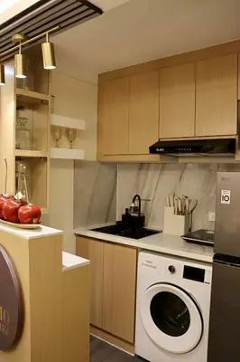 a kitchen with a washing machine in a kitchen at Palacio Inglaterra in Manila