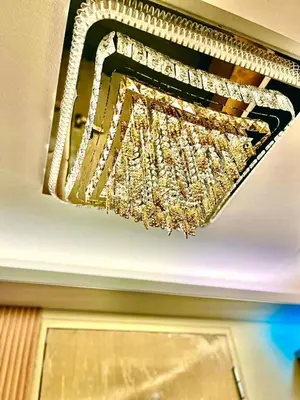 a gold chandelier hanging from a ceiling at Palacio Inglaterra in Manila
