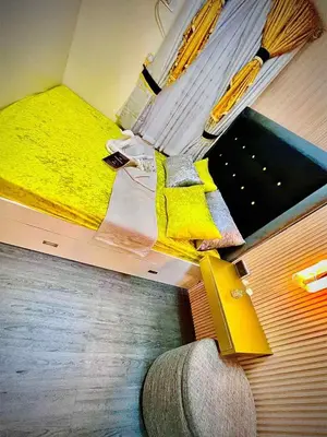 a room with a bed with yellow sheets and a yellow blanket at Palacio Inglaterra in Manila