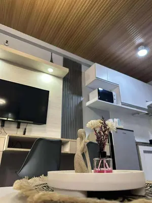a room with a table with a statue on it at Stay at FB Harrison near World Trade Center MOA and NAIA in Manila