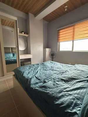 a bedroom with a large bed and a window at Stay at FB Harrison near World Trade Center MOA and NAIA in Manila