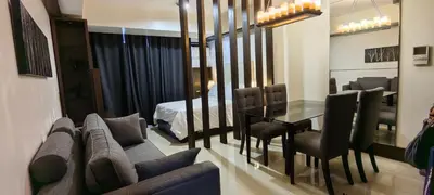 a living room with a couch and a table with chairs at Greenbelt Excelsior in Manila