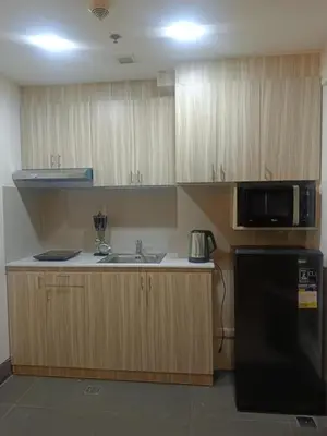 a kitchen with a sink and a microwave at Greenbelt Excelsior in Manila