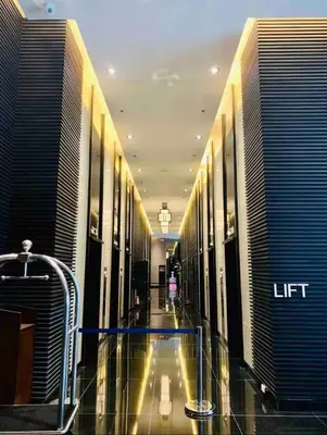 a hallway of a building with a lift sign on it at Cozy Escape by Dave 4563 in Manila