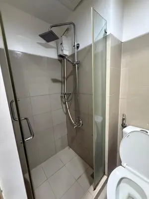 a bathroom with a shower and a toilet at Shore 1 residences Tower D Pasay City in Manila