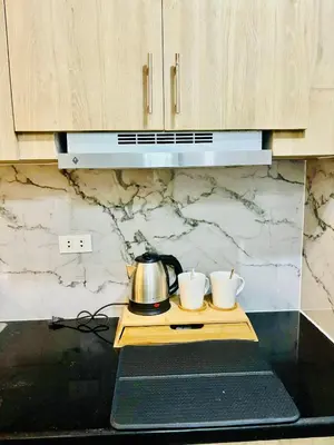 a kitchen counter with two cups and a tea kettle at Shore 2 Residences Tower 1 in Manila