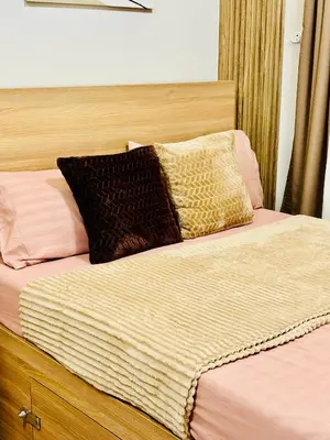 a bed with two pillows on top of it at Shore 2 Residences Tower 1 in Manila